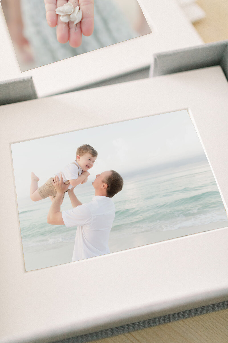 Close-up of matted portrait prints from a Destin beach session, presented in a fine art box