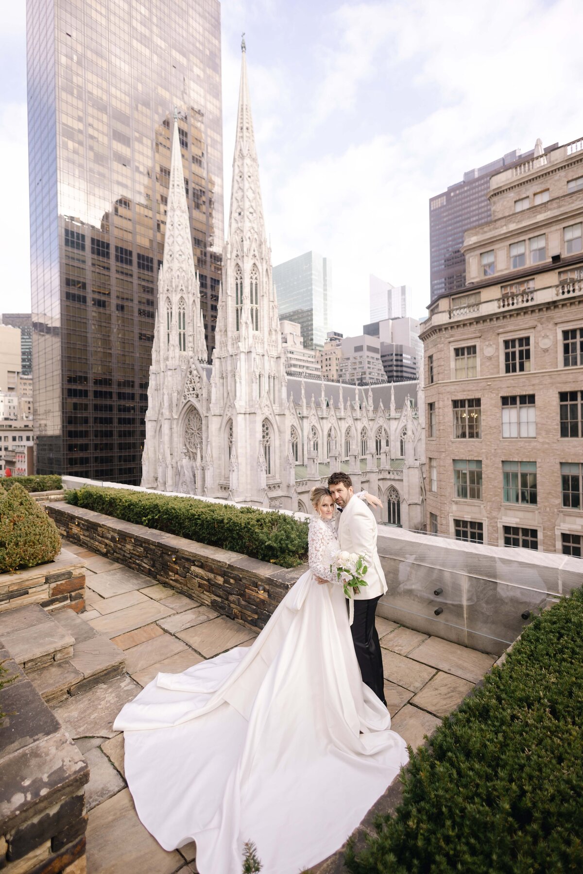 Wide angle photo of a bride and groom on a rooftop