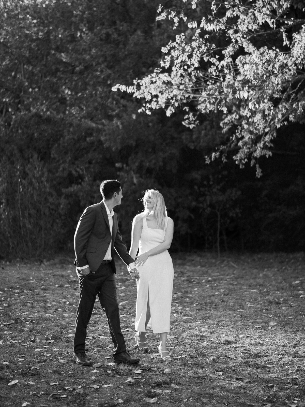 Engaged couple holding hands and laughing