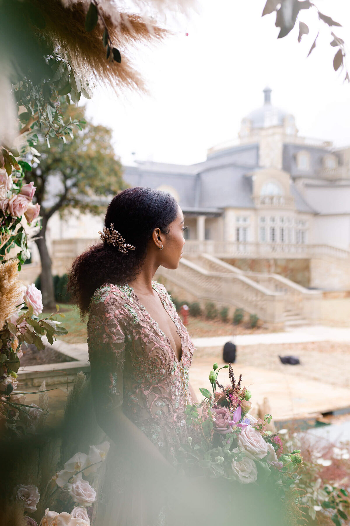 bride looks out at her wedding venue The Olana in Dallas Texas by Swish and Click Photography