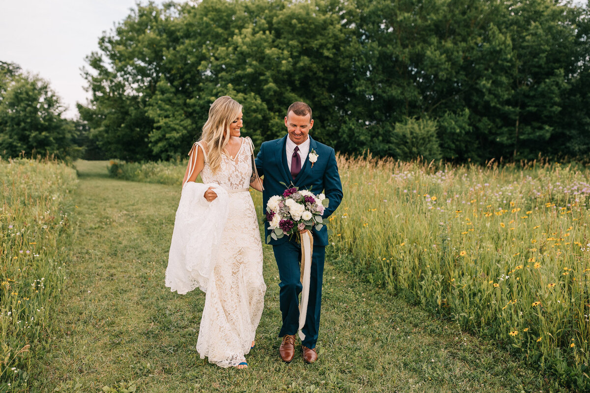 Bride and groom walking down the lane with arms wrapped around each other