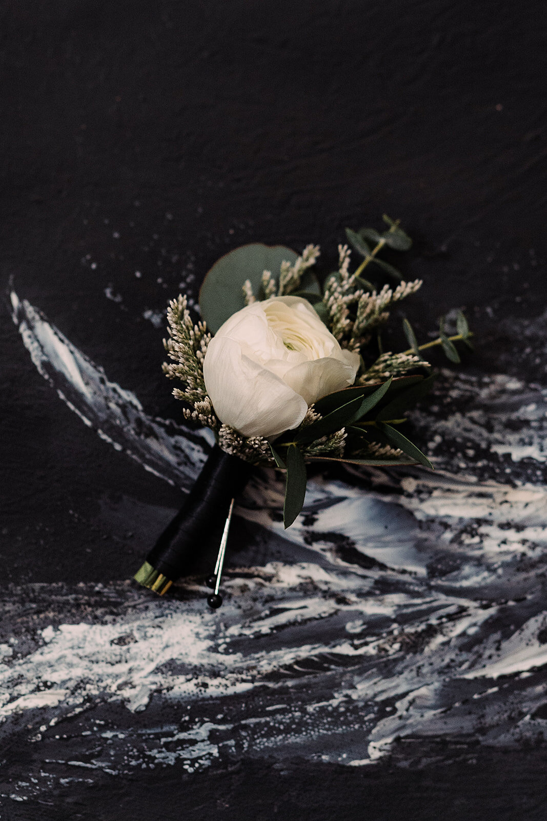 A flower sits on a black marble background
