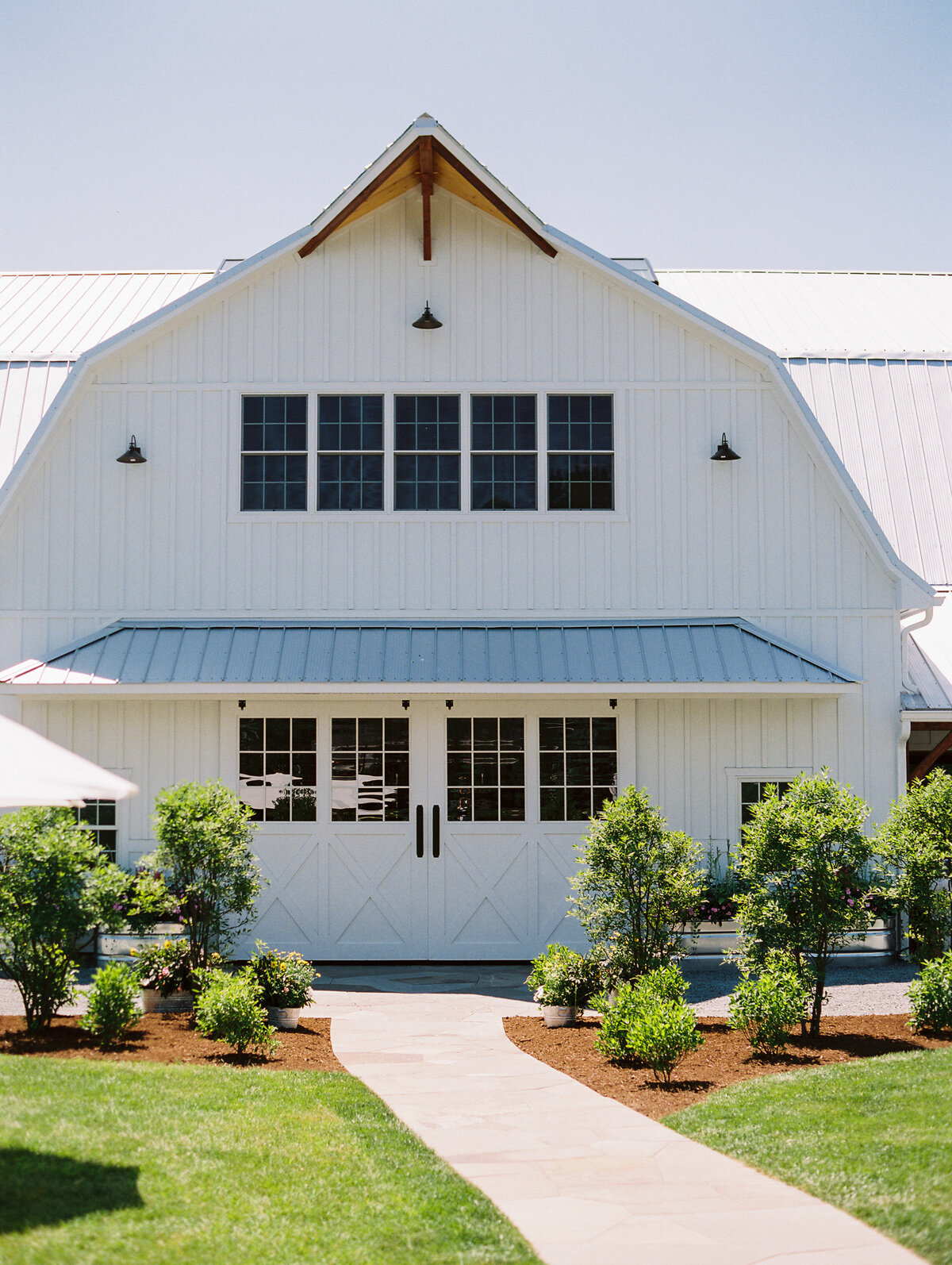 Exterior photo of the Wildflower On Watts white barn venue