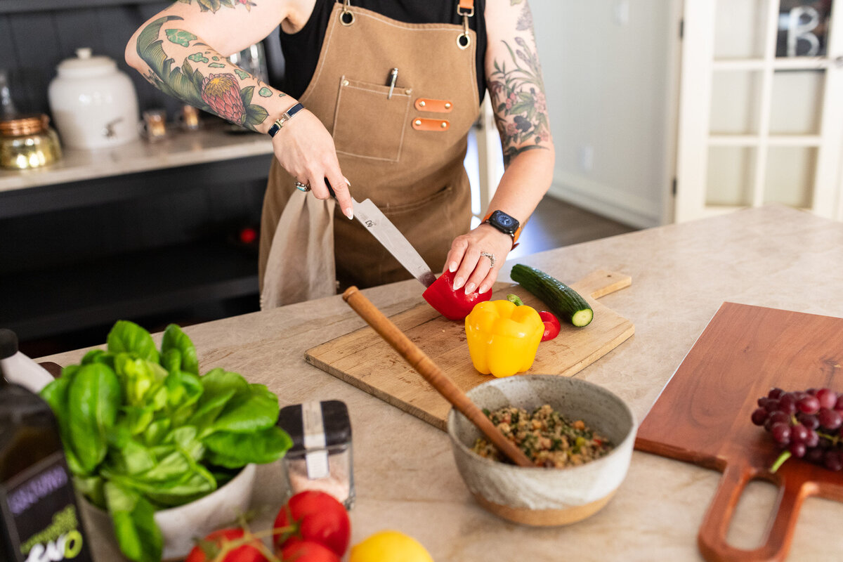 woman cuts yellow pepper during portland headshot session