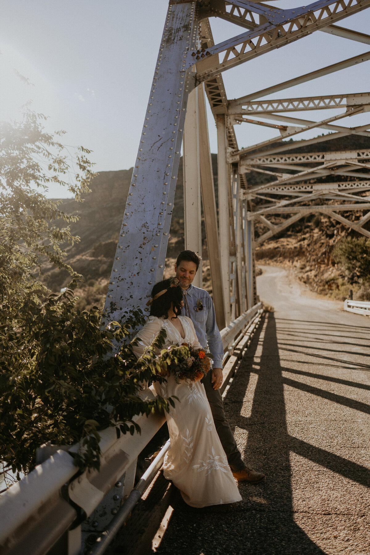 newlyweds standing on a bride above the Rio Grade in New Mexico