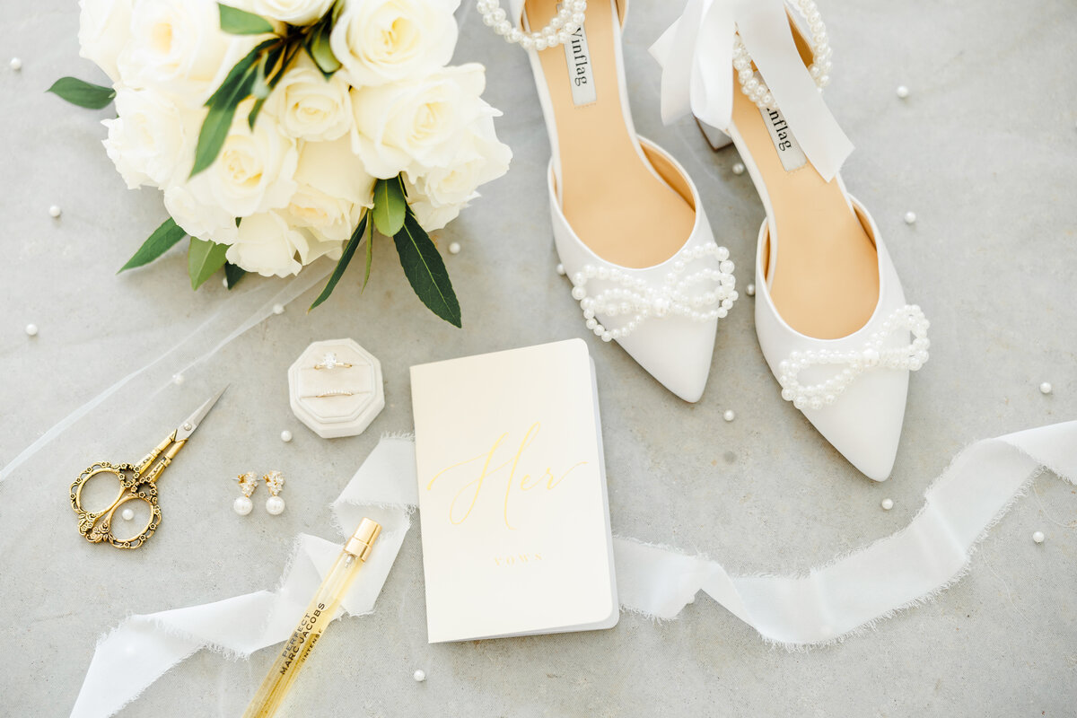 Bridal details with shoes, bouquet, vows, and rings.
