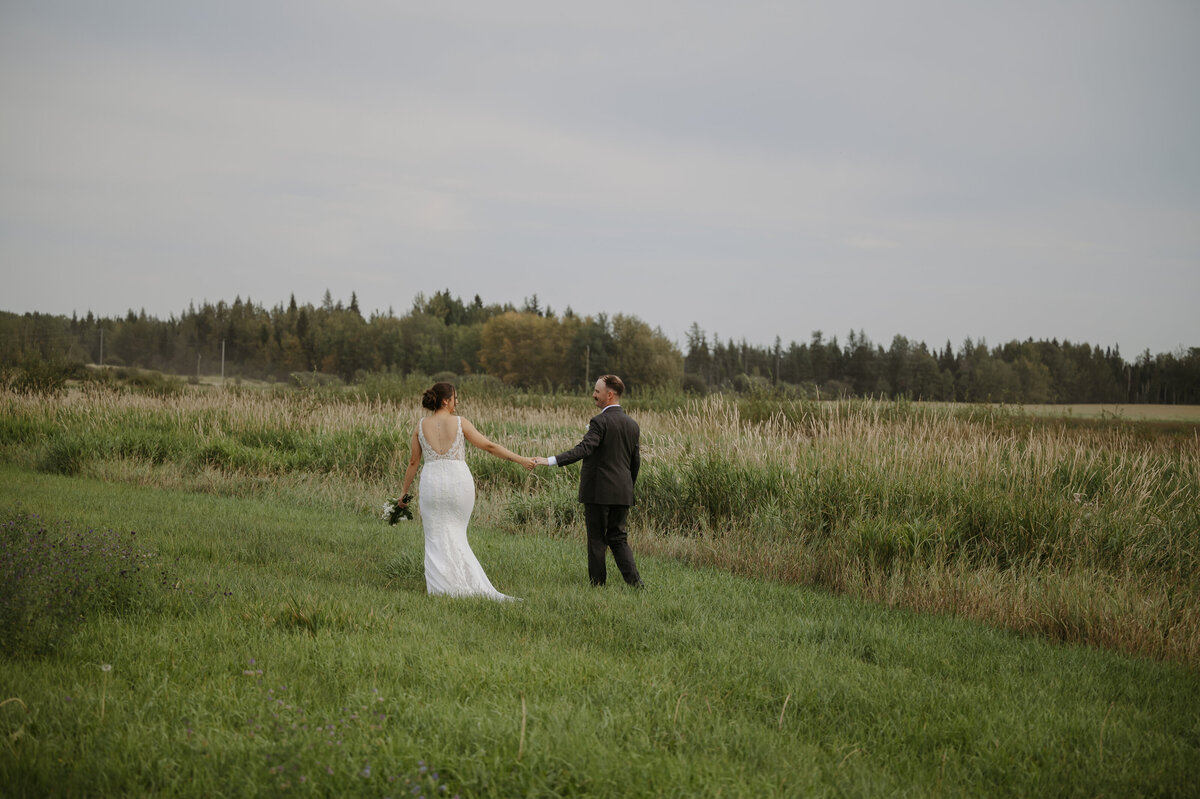 bride and groomw alking at sunset