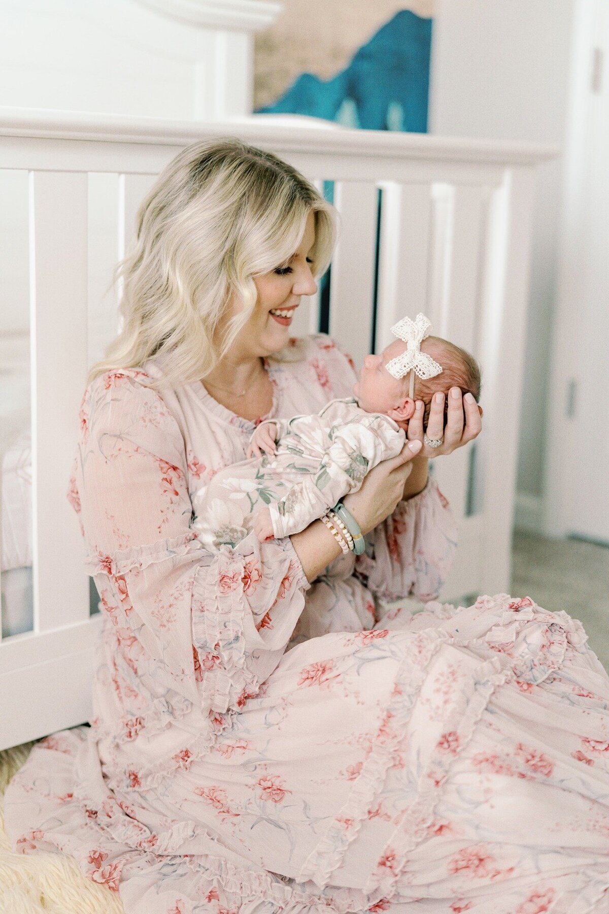 mom-sitting-in-nursery-holding-newborn-girl