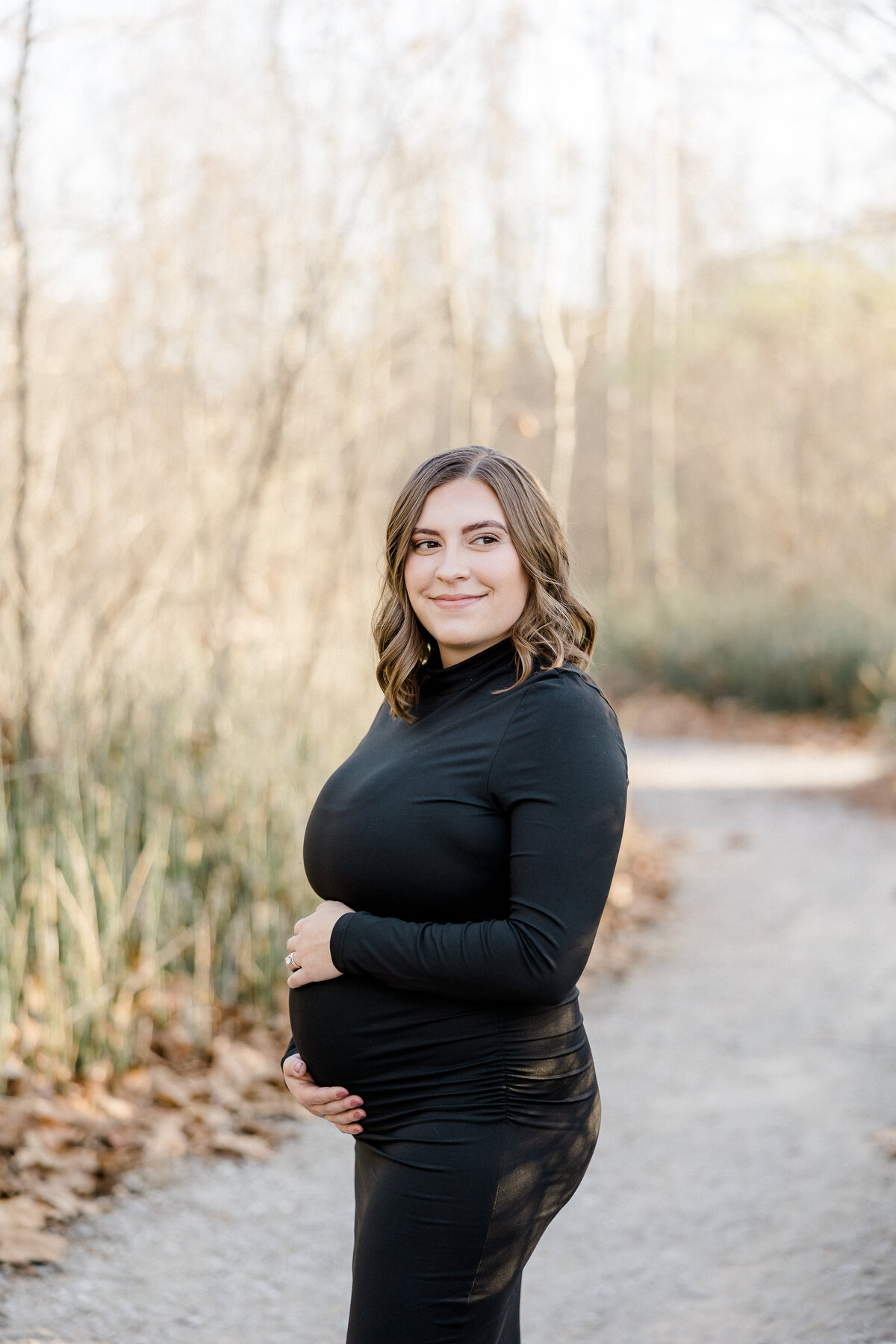 pregnant mama smiling over her shoulder during maternity photos