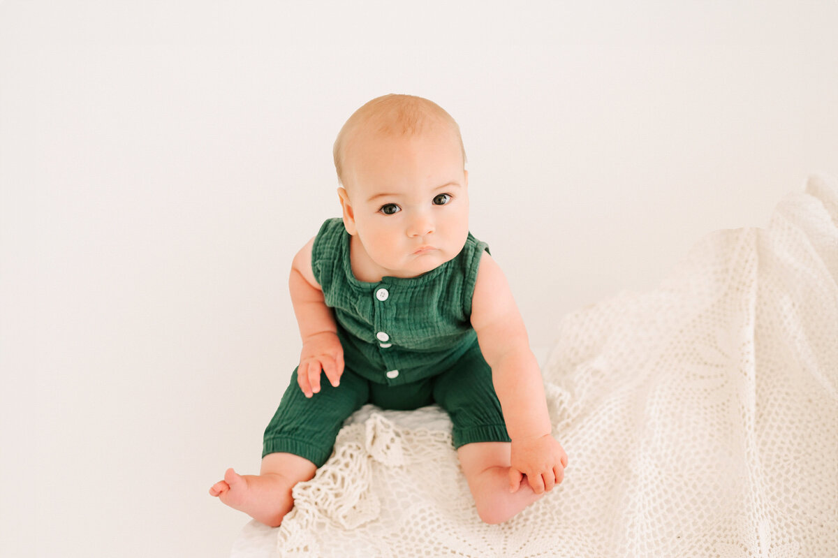 boy holding his toes during kids photography session in Springfield MO