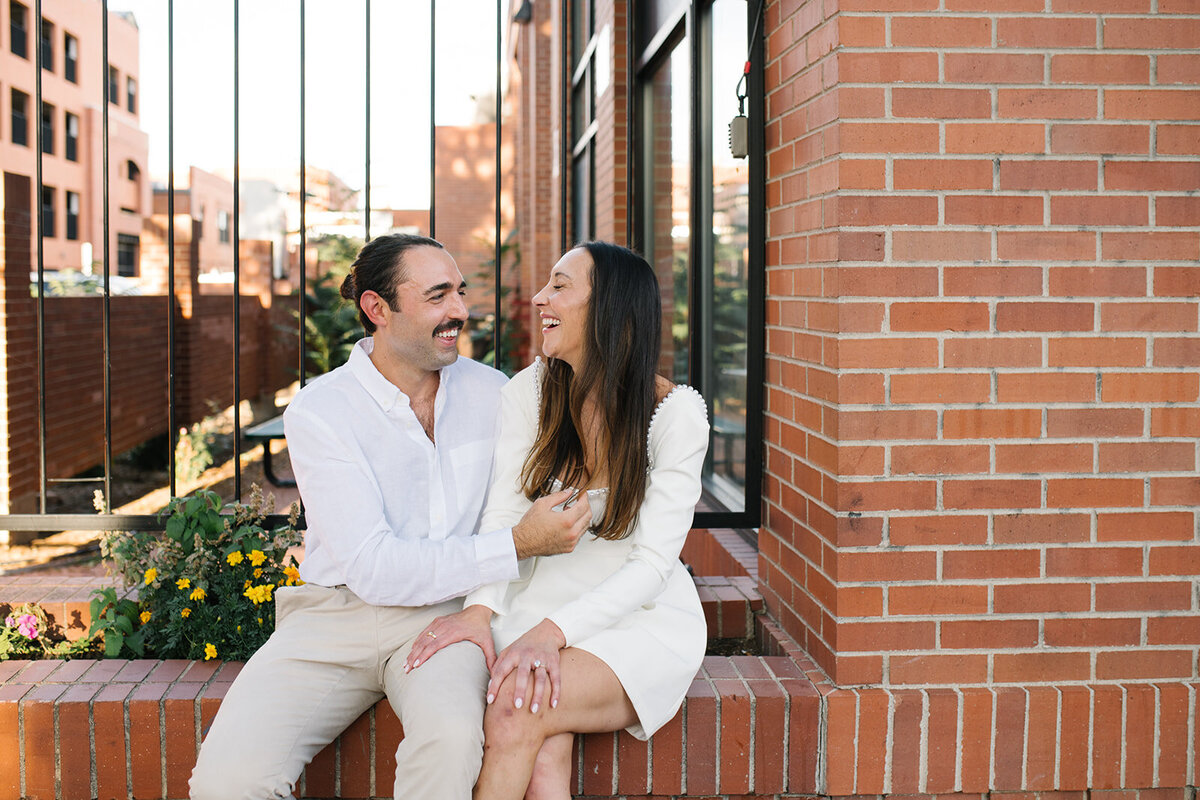 Couple laughing during engagement session in Denver’s foothills