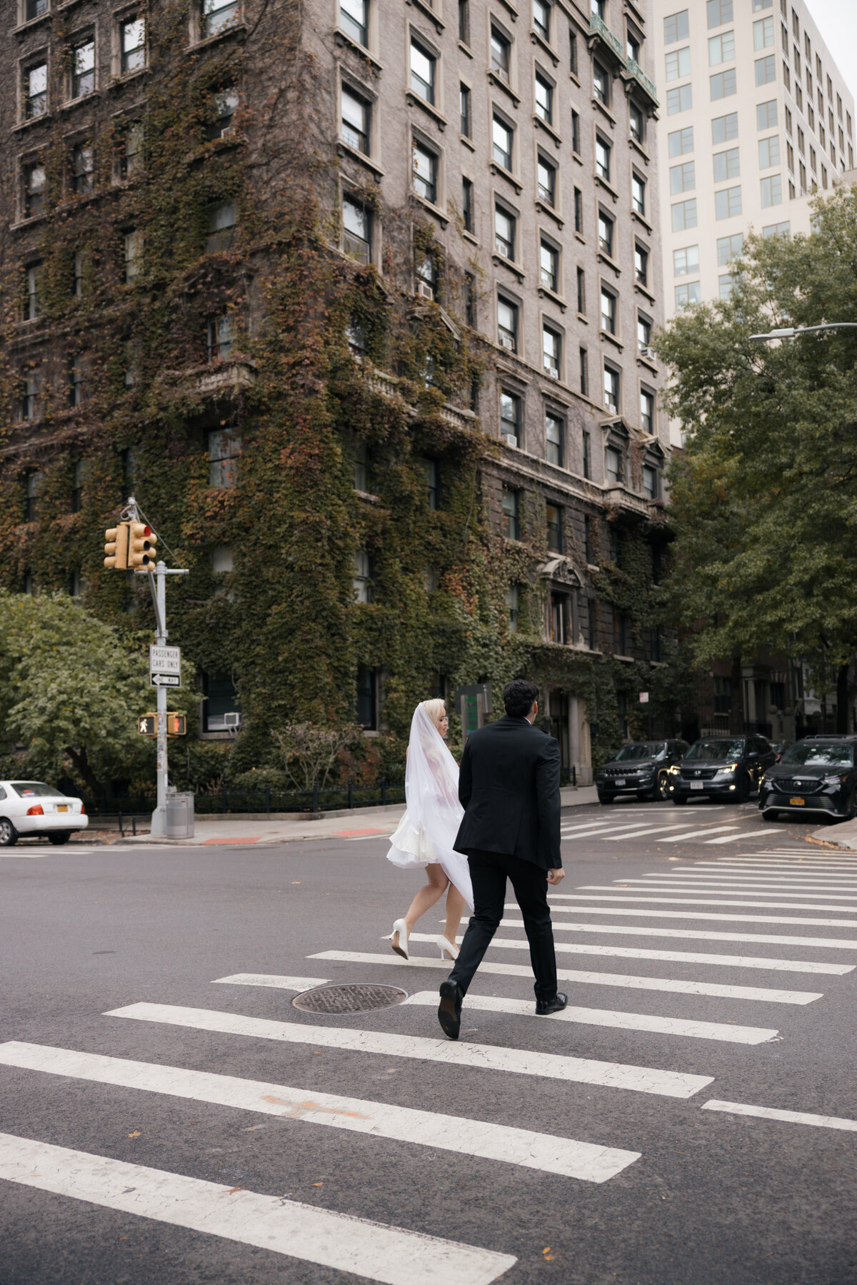 Elopement couple sharing a romantic moment in front of a brick building in NYC.