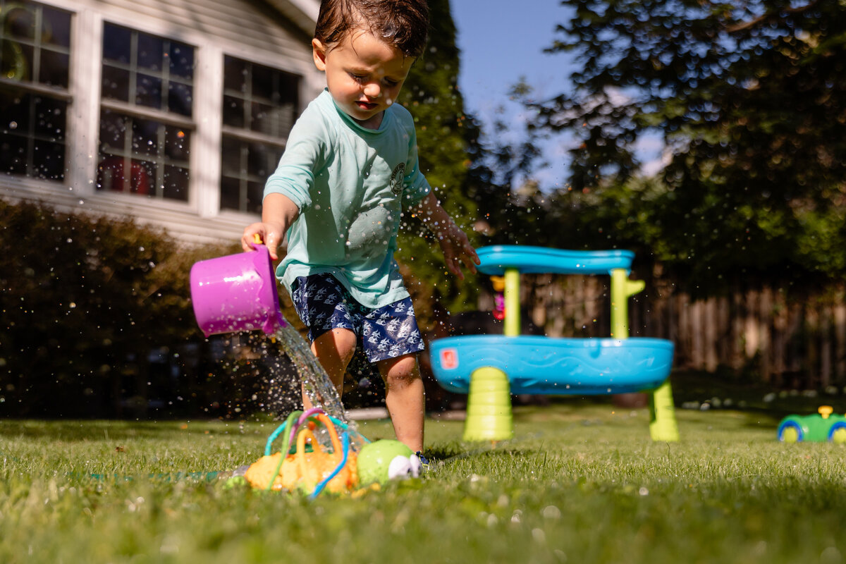 toddler-playing-water-backyard