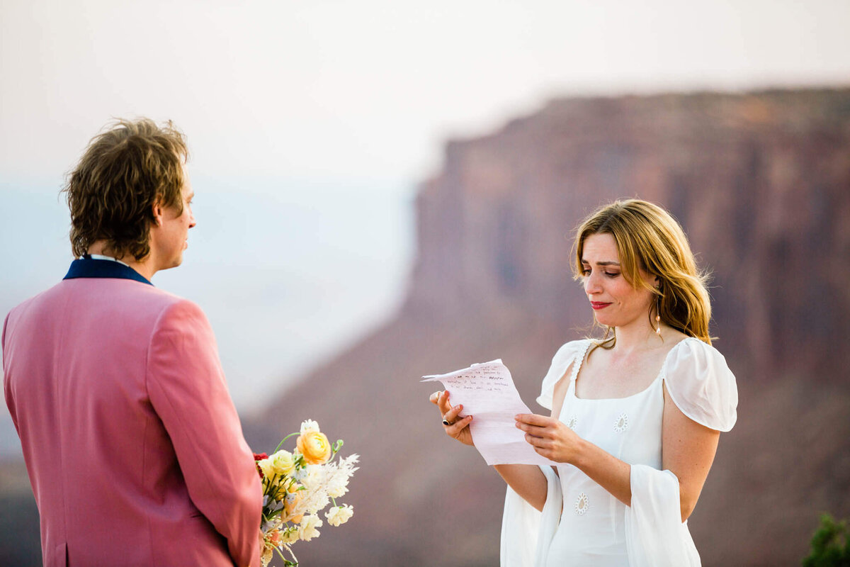 the couple, having just eloped, smiles in the desert.