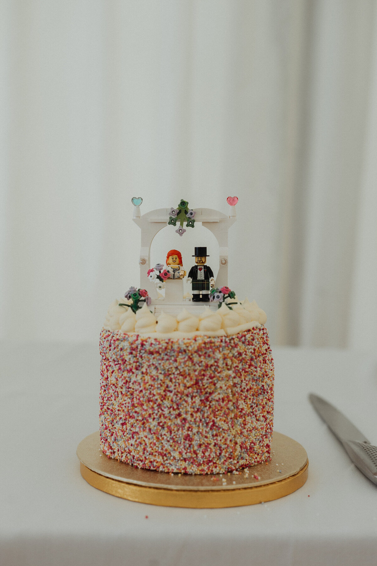 lego bride and groom wedding cake with sprinkles