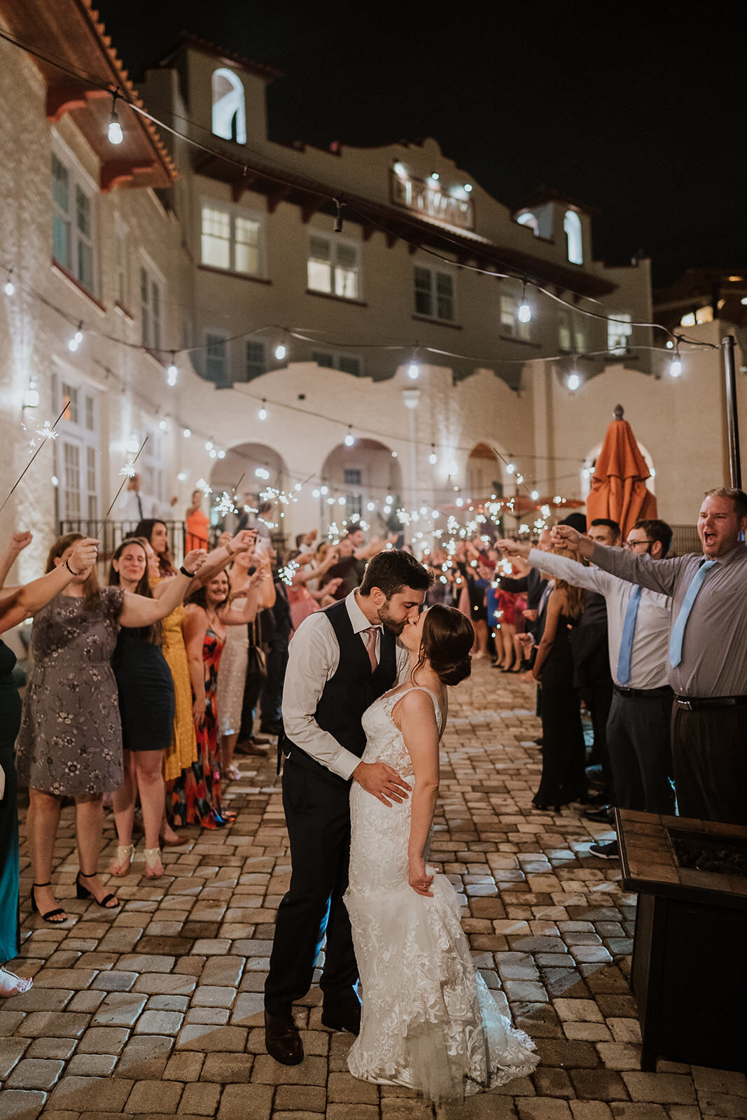 bride and groom kiss under sparkler exit at the fenway hotel dunedin florida
