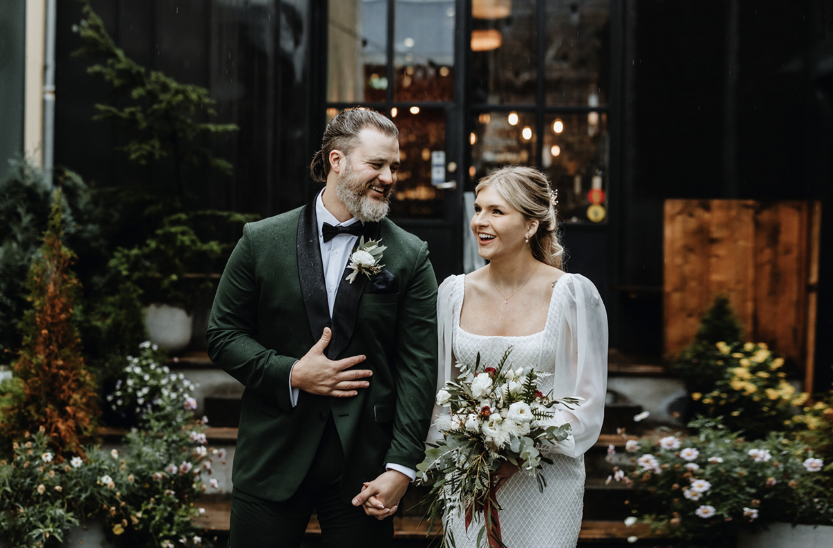 Bride and Groom after their first look laughing and holding hands in a hotel in Reykjavik Iceland