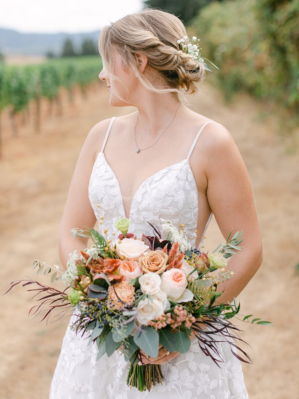 Bridal bouquet in the hands of a bride with flowers in her hair.