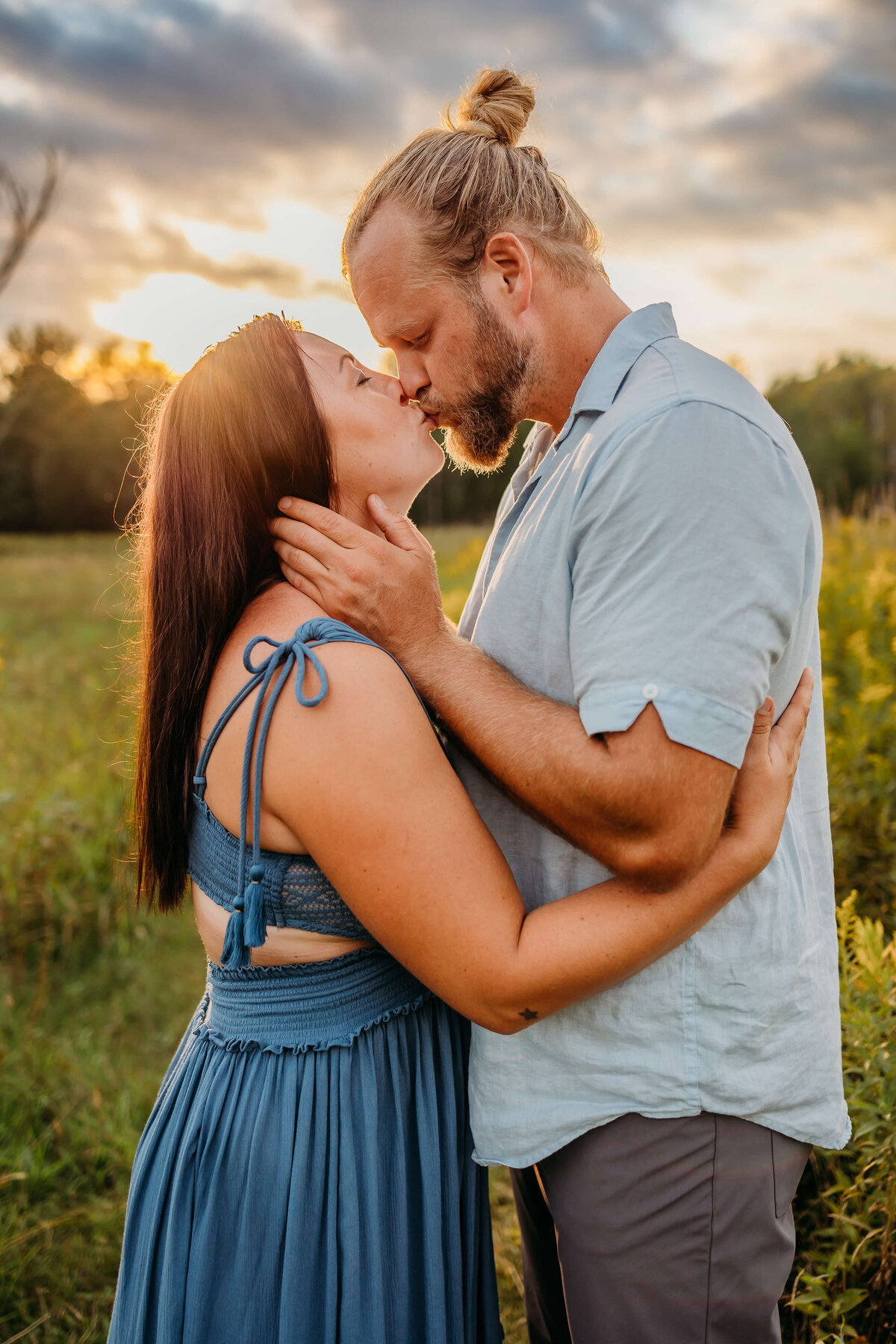 couple kissing at sunset at farm