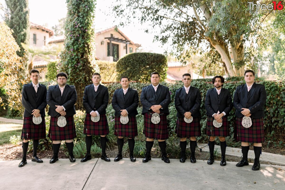 Groom and Groomsmen pose for photos in their wedding day kilts