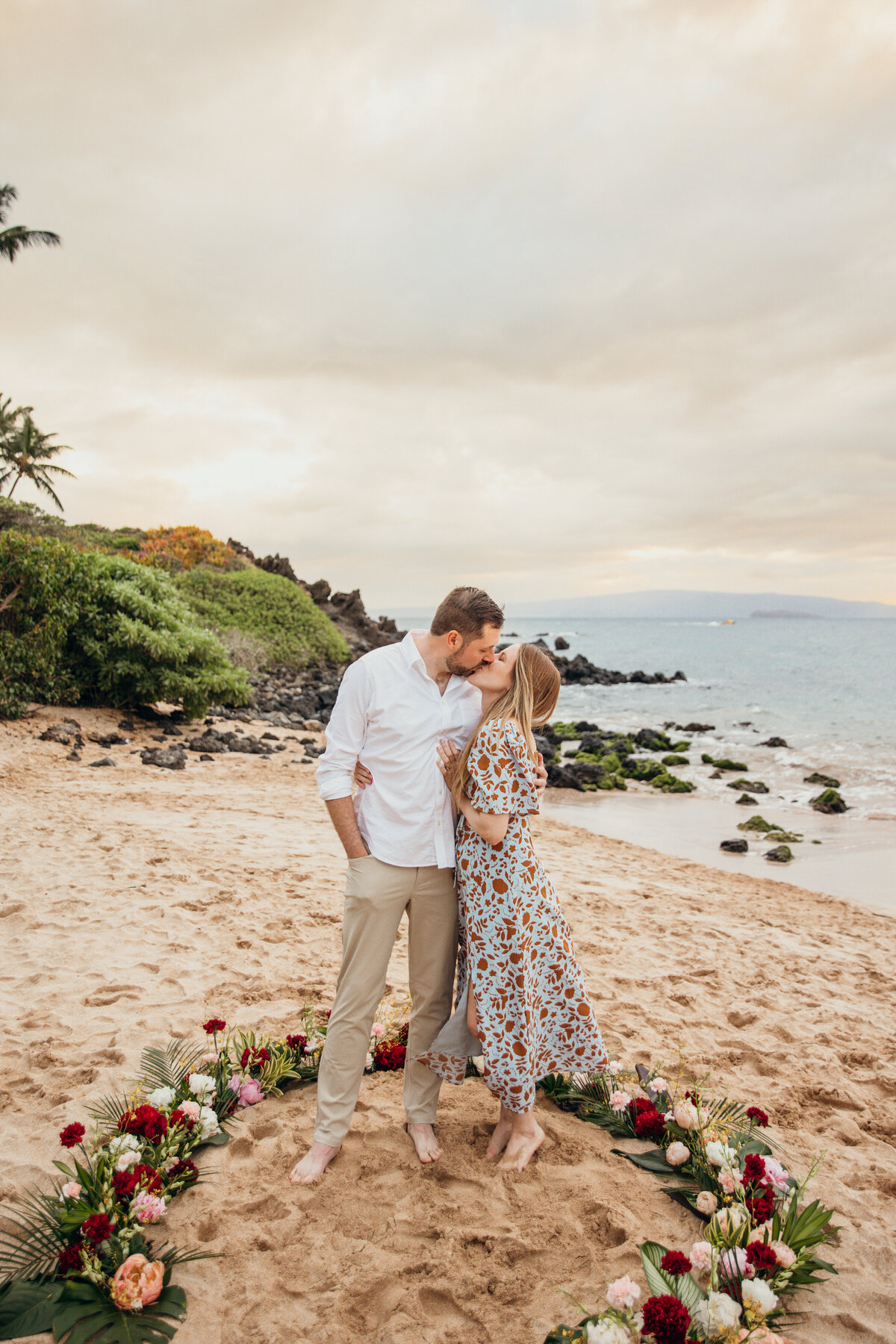 Hawaii Engagement Photographer captures couple kissing after intimate beach proposal
