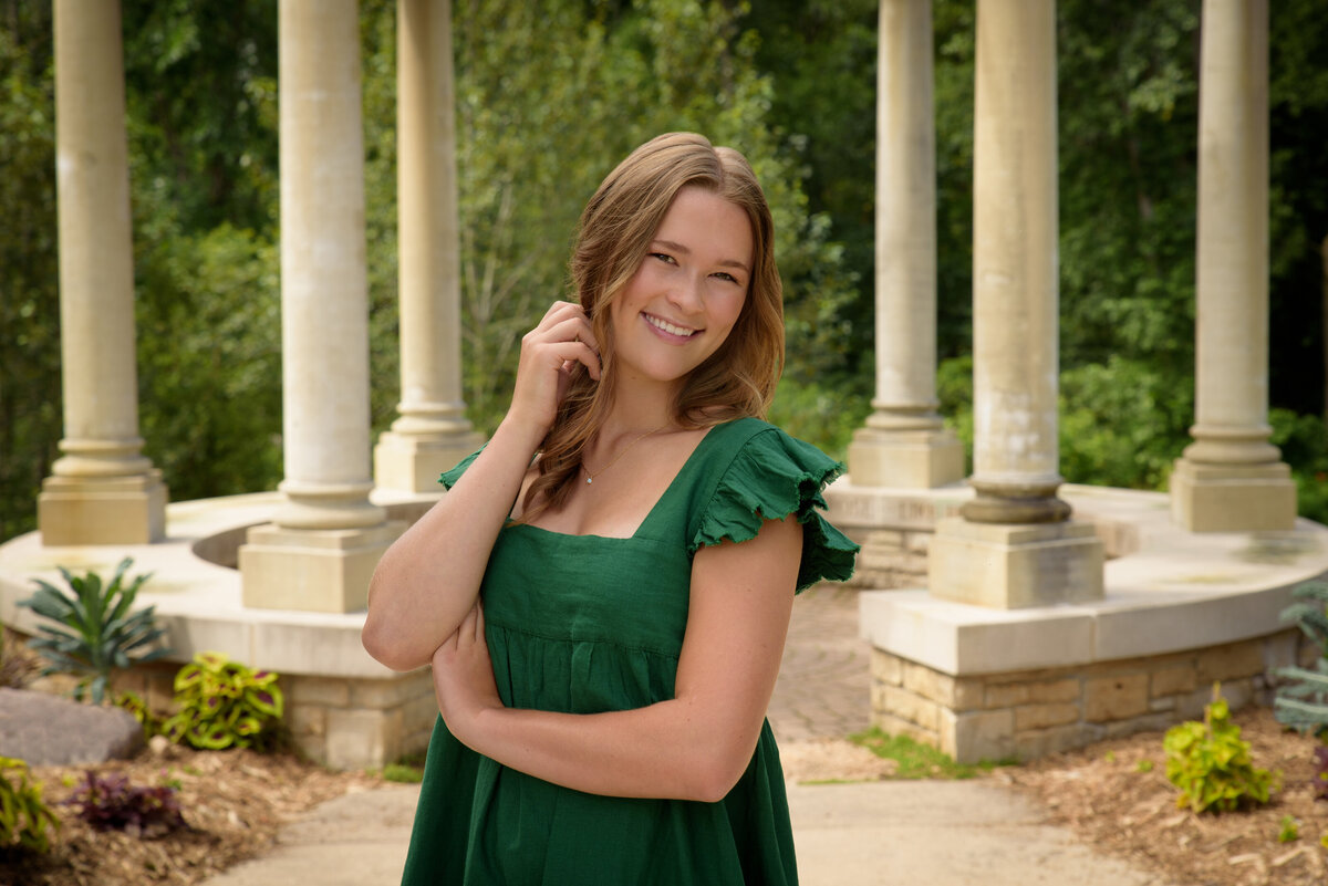 Luxemburg Casco High School senior girl wearing short kelly green dress in the flower gardens at the Green Bay Botanical Gardens in Green Bay, Wisconsin