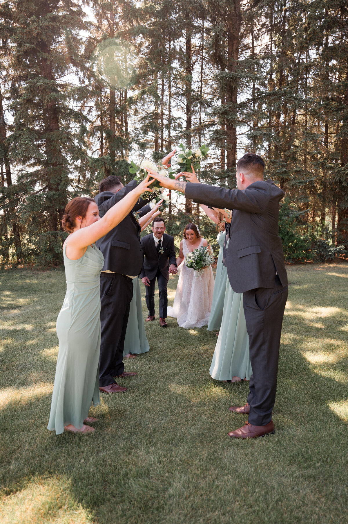 wedding party created a tunnel for bride and groom to run through