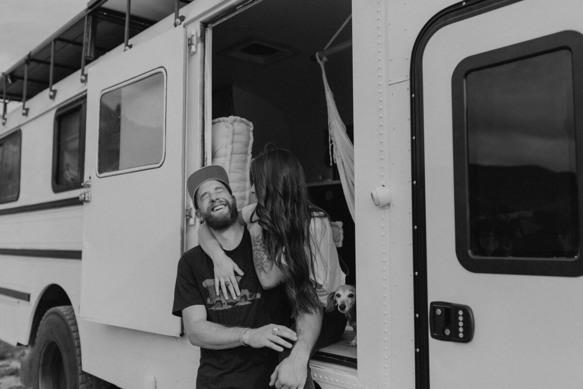 black and white image couple embracing in van