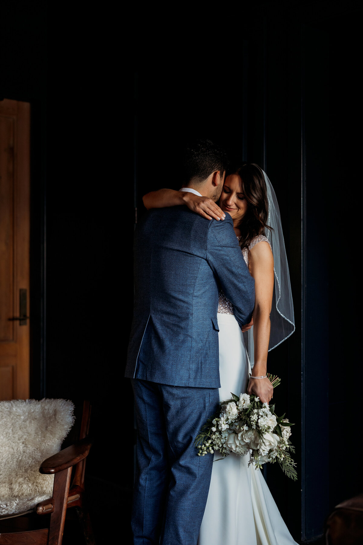 Quiet moment in a dark room for the newlyweds before the reception begins
