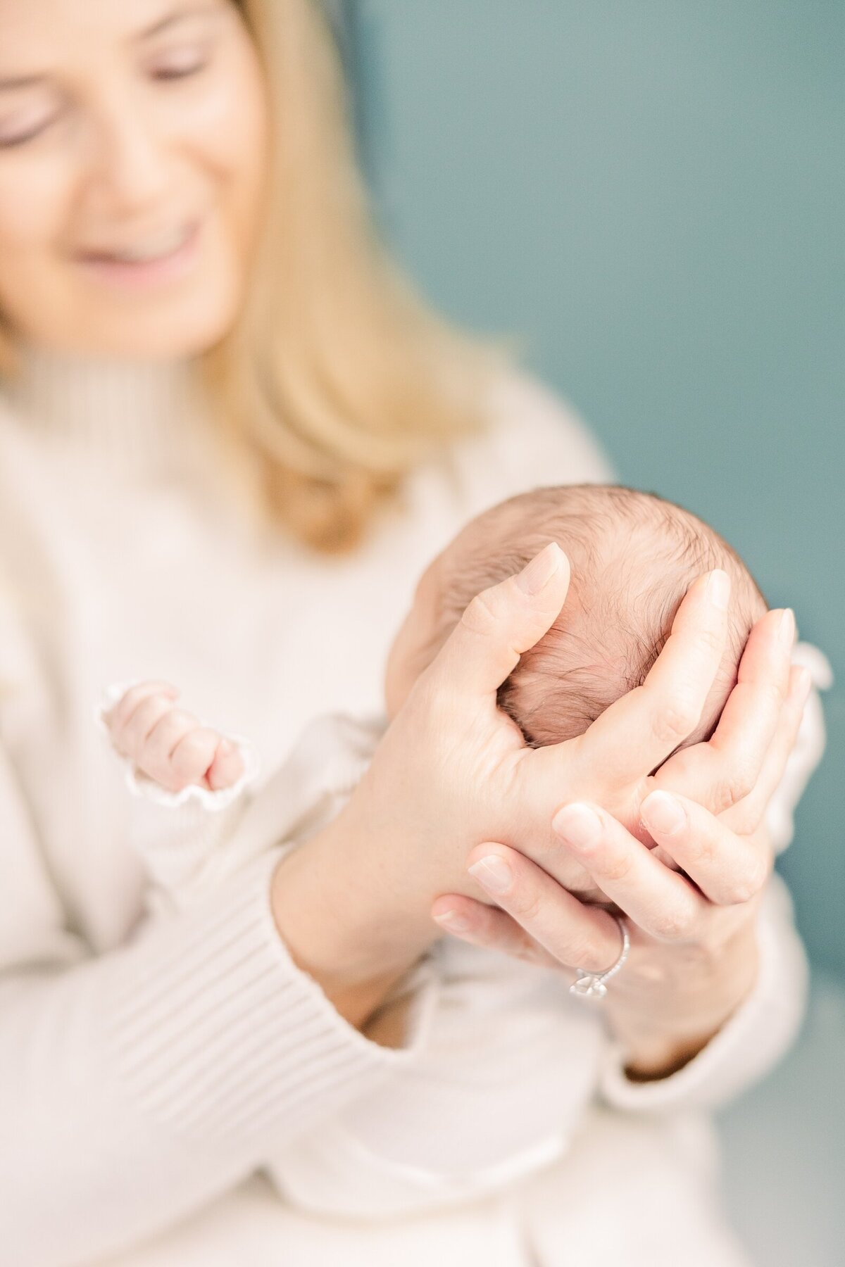 Mom gazing down toward newborn baby girl for Erin Thompson Photography