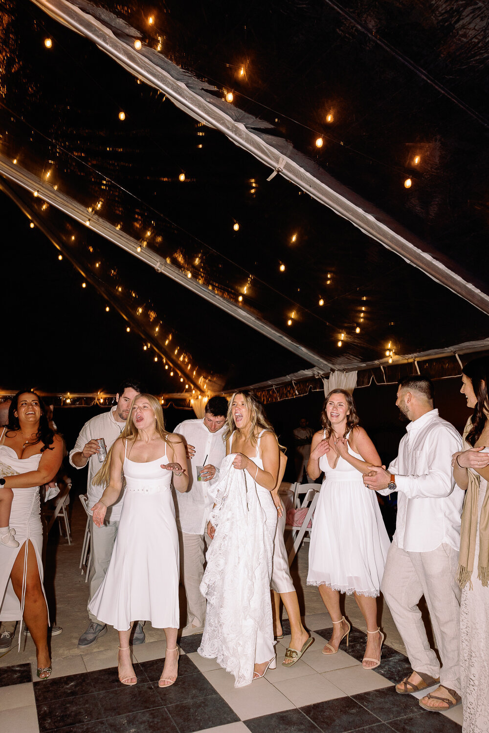 Guests dancing under the twinkling lights at Laura and Abraham’s wedding reception at Cheeca Lodge Resort.