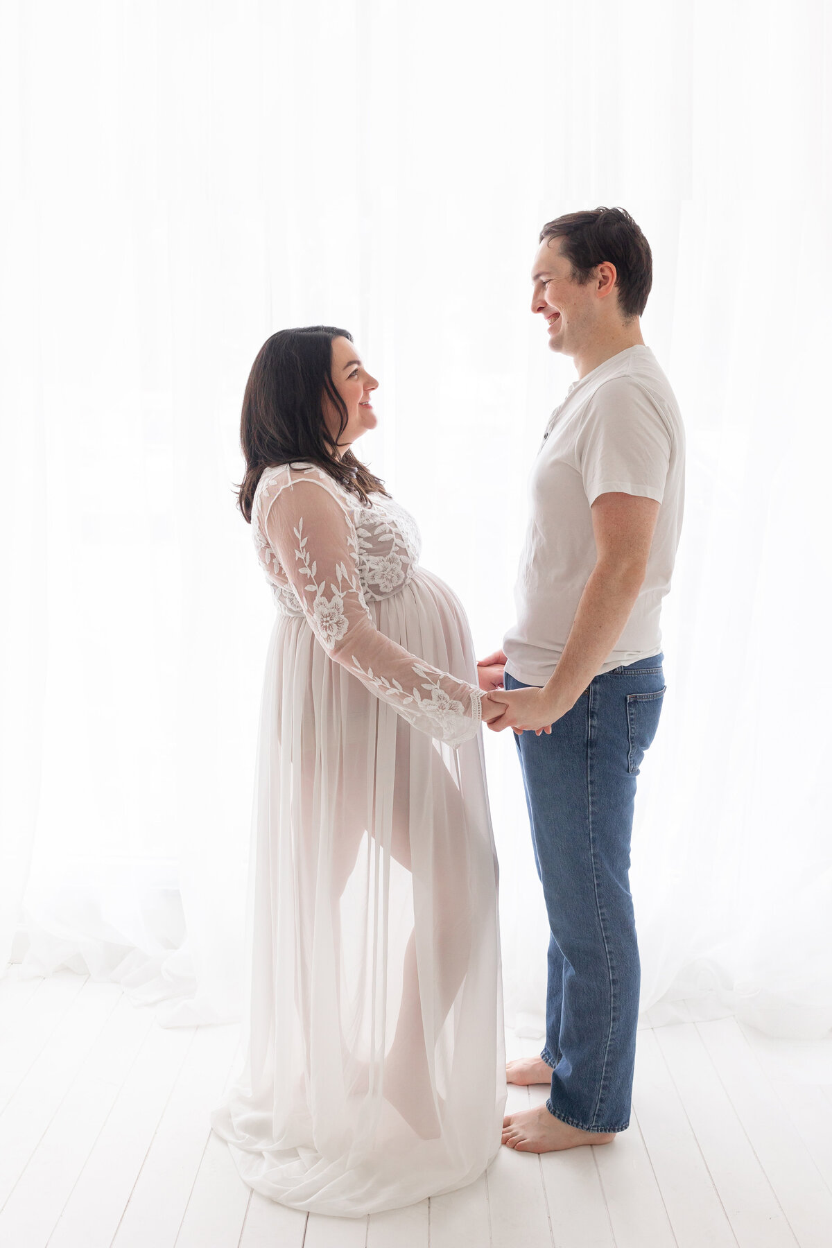 expecting parents smiling at each other