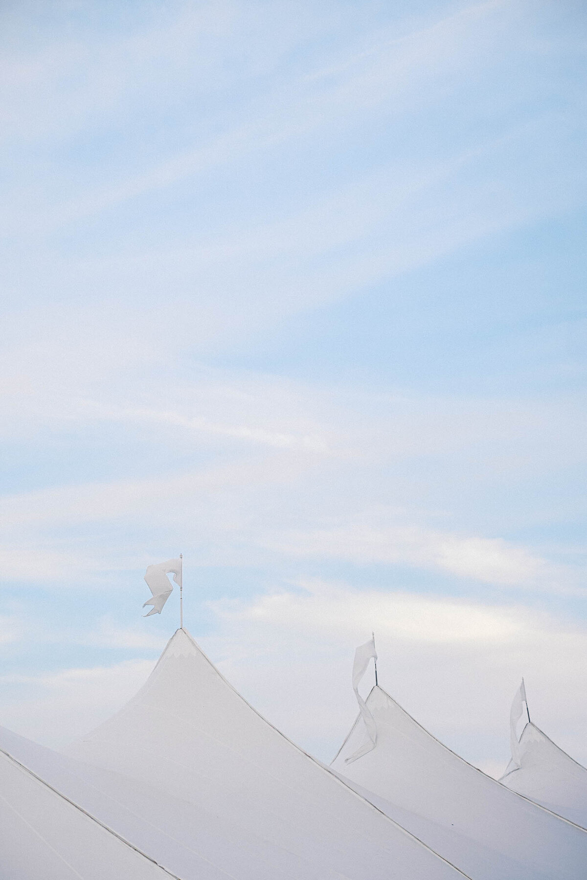 tent flags at crane estate in ipswich taken by boston documentary wedding photographer