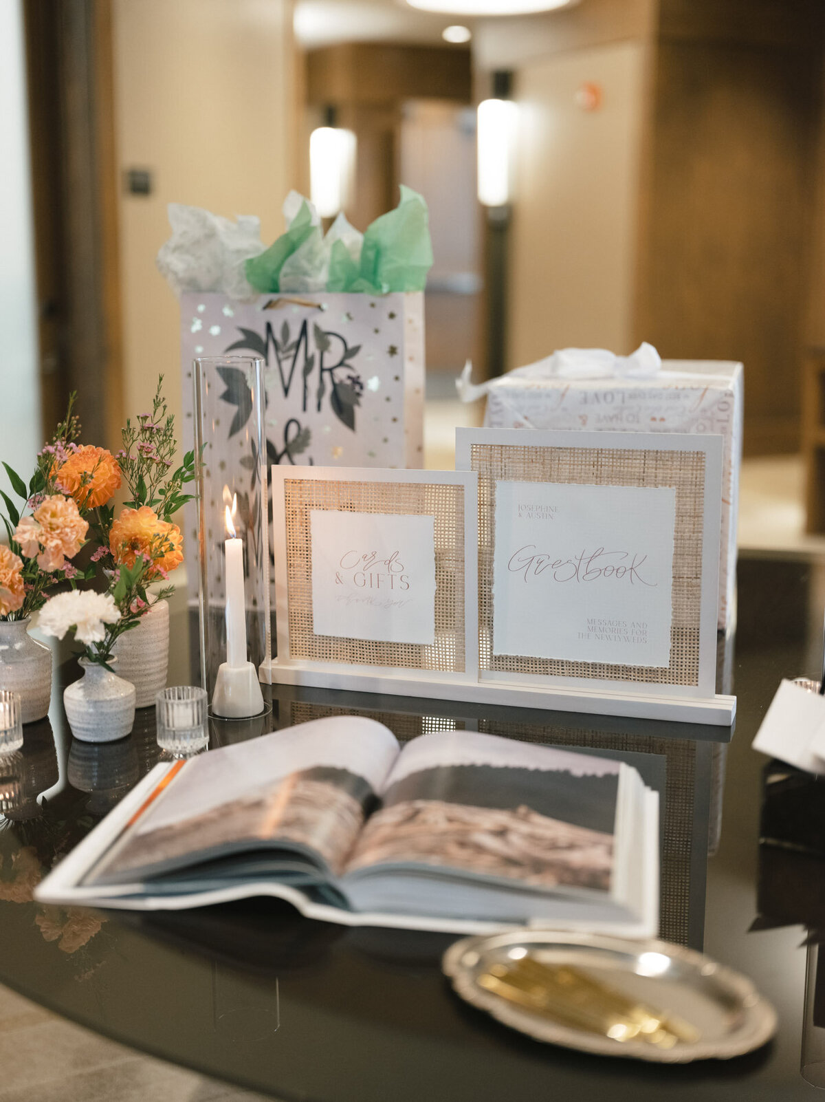 custom calligraphy cards and gifts sign on a wedding table with florals and gifts representing full service design and calligraphy by Life in Letters.