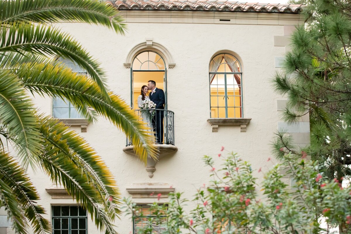 Bride and Groom in the window of the Powel Crosley Estate in Sarasota, Fl.