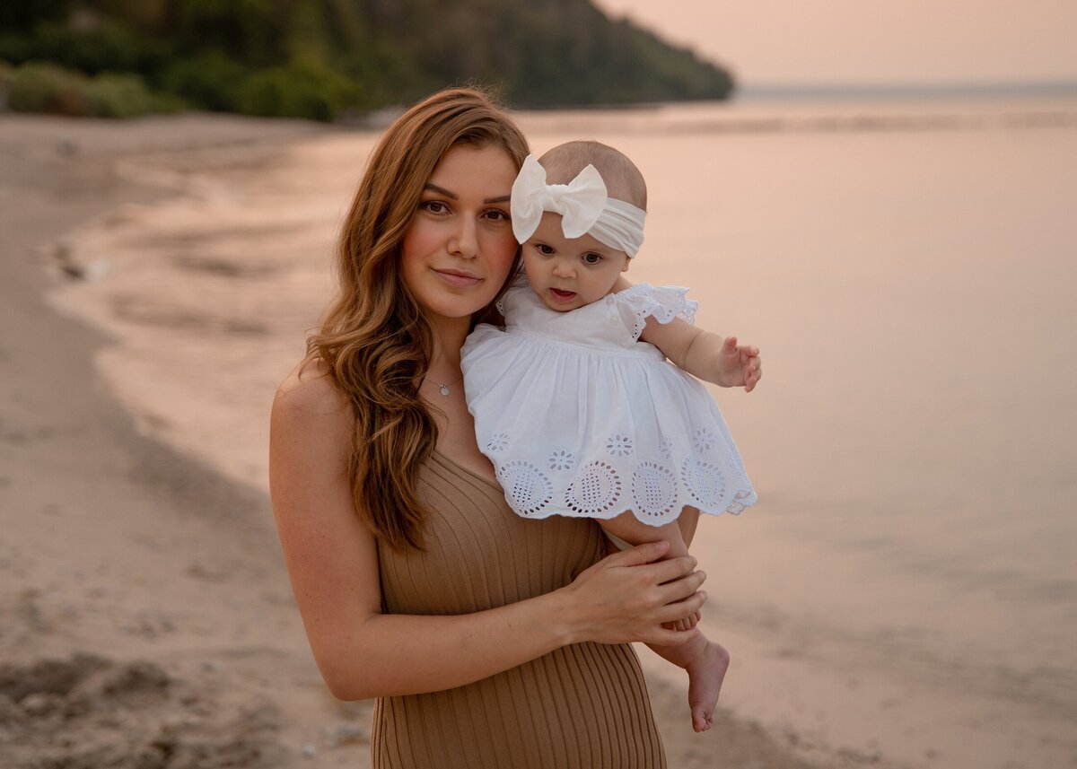 holding kid at beach