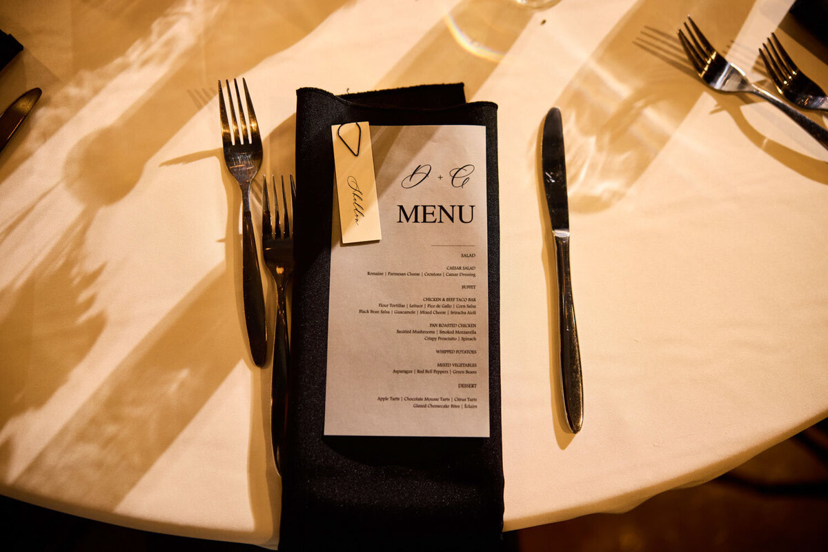 Dining table with white cloth and black napkin