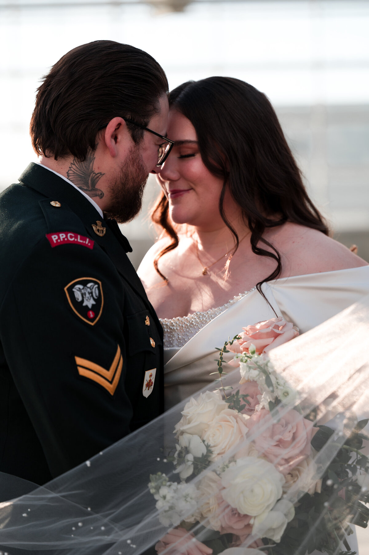 bride and groom stand with foreheads together for a romatic wedding photo