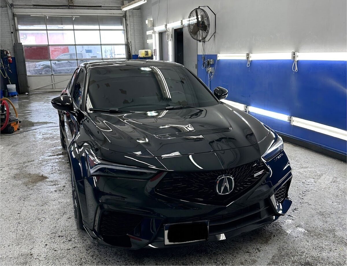 Black luxury car being washed at Superstar Auto Spa. This image showcases our meticulous car wash process, using high-quality products and techniques to ensure a spotless finish.