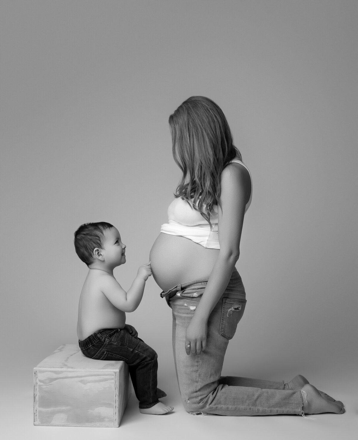 Intimate black and white maternity portrait by Manor maternity photographer with studio lighting