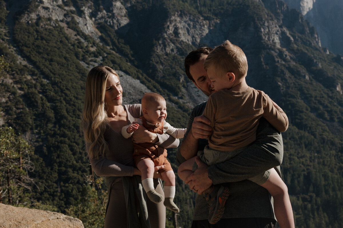 A family sharing an intimate moment against Yosemite’s dramatic mountain backdrop, photographed with a luxury wedding photography approach.
