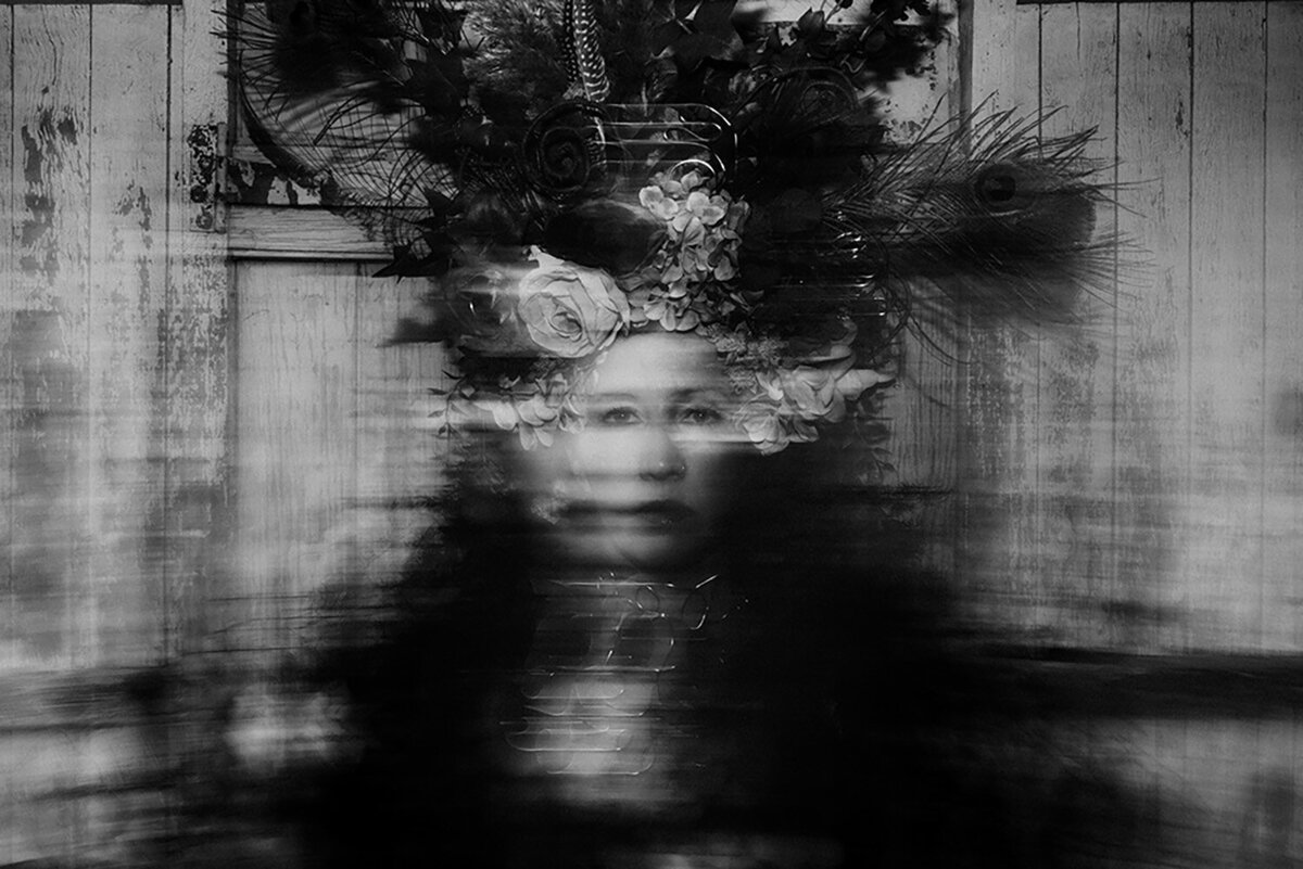 Sunshine Coast Brand Photograph in motion of a woman with a headdress on, blurred from motion.