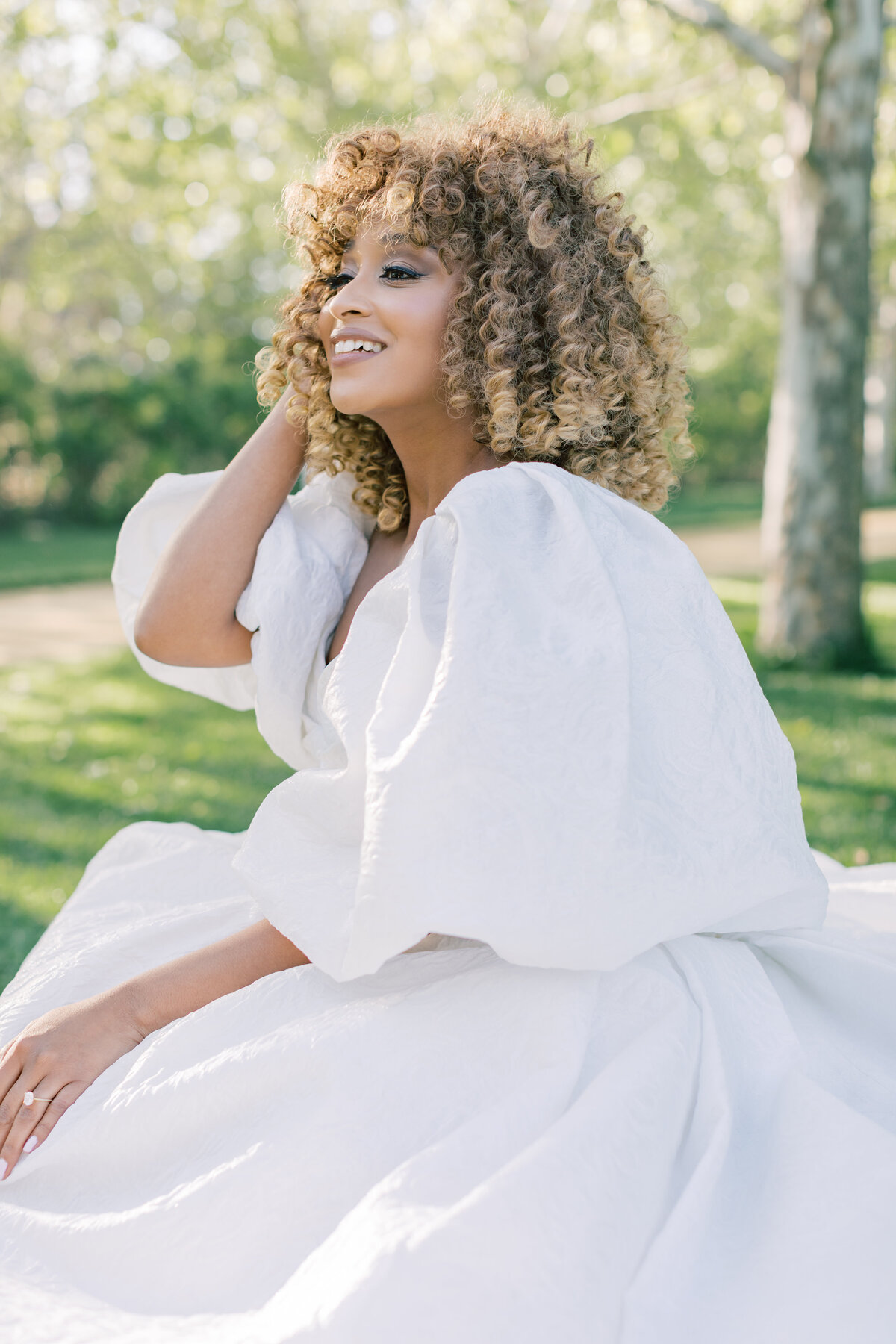 elegant-bride-portrait-natural-light-curly-hair-charming-smile