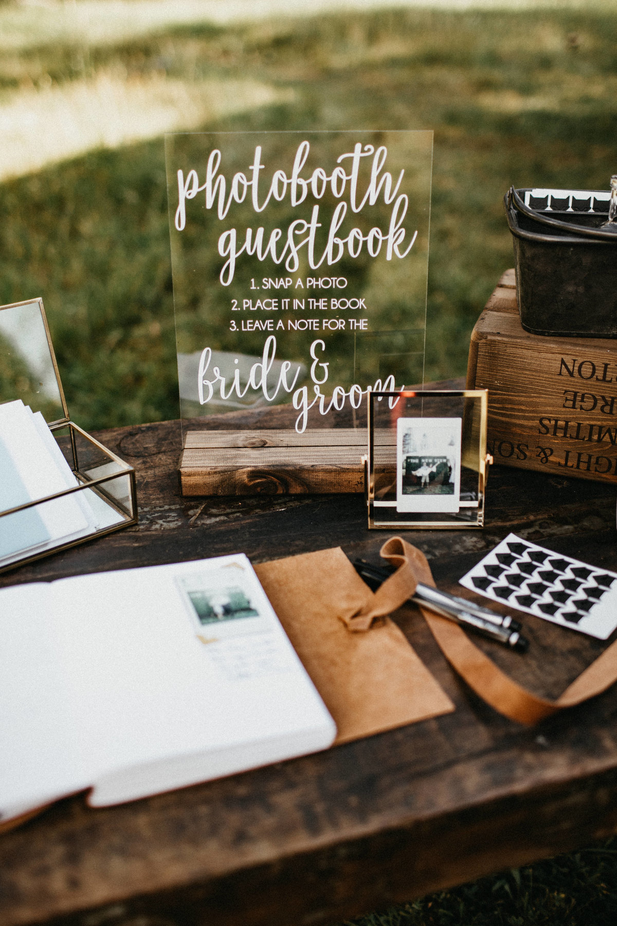Tahoe Wedding Planners wood table leather guestbook acrylic sign at summer wedding venue Mitchell's Mountain Meadows Sierraville near Truckee, Joy of Life Events image by Luk (2)