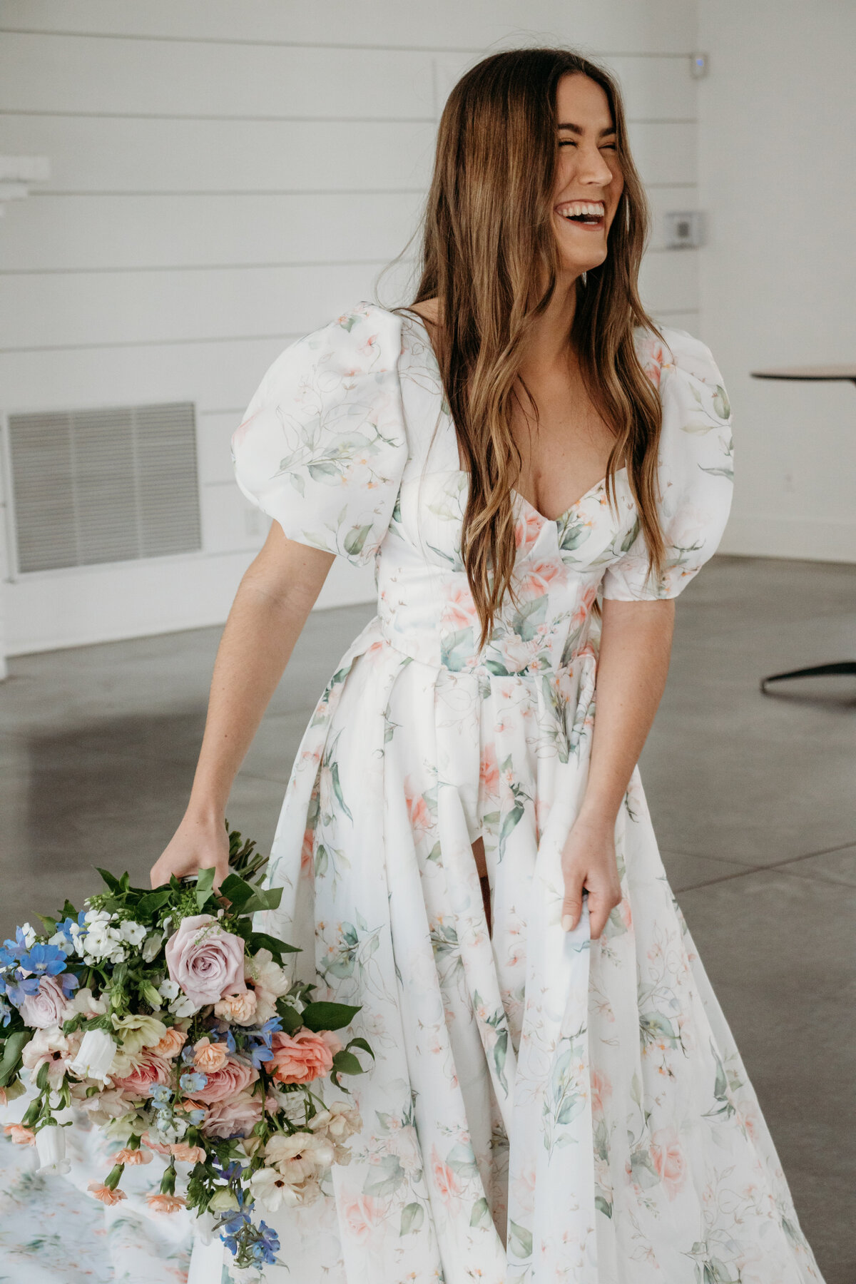 The bride giggles to her wedding party as a Duluth wedding photographer, S Jacobson Photography, captures her Hutton House wedding.