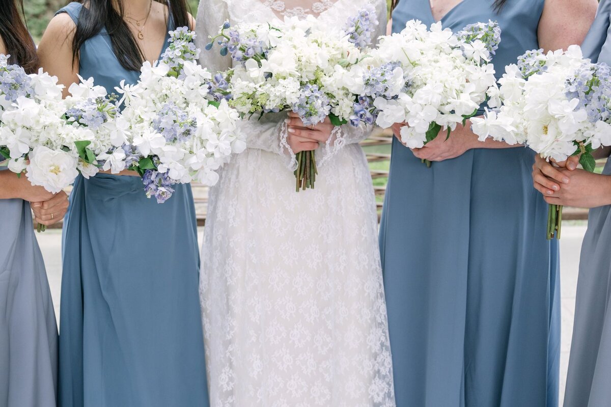 close photo of bride and bridesmaid bouquet in white and powder blue