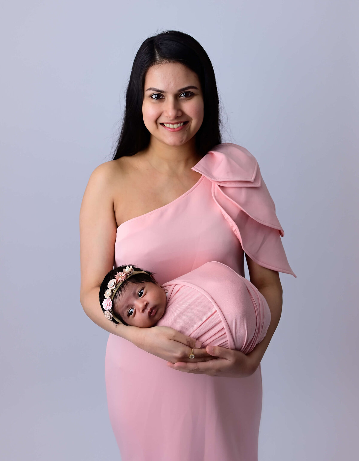 Photographer Beth Benecki of E. Benecki Photography photographs new mother and her newborn daughter both dressed in pink.