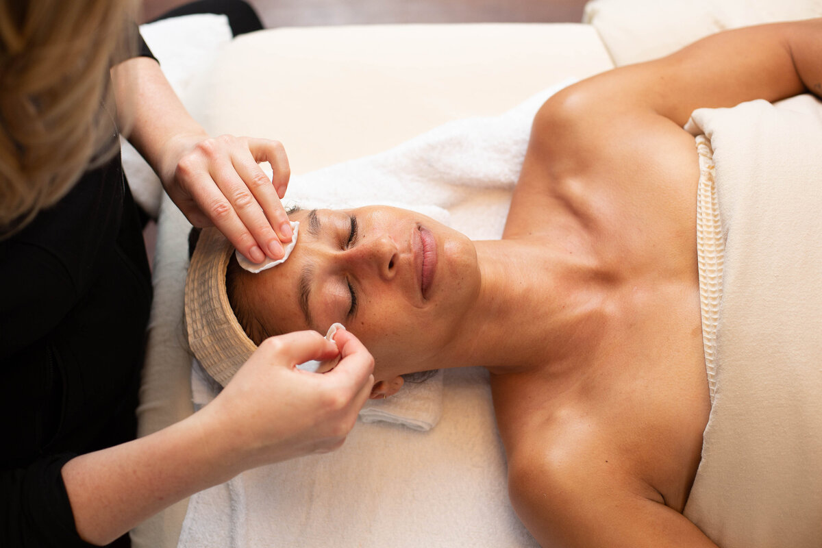 Beautiful woman receiving a facial at a spa
