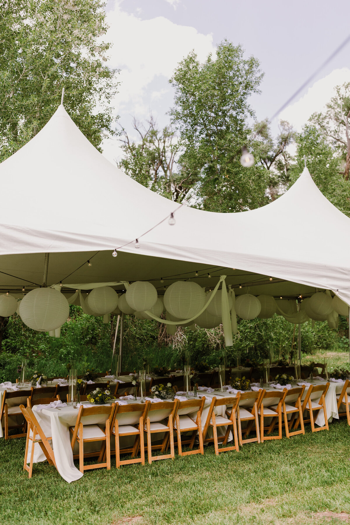 Wedding reception tables under white marquee at Dallenbach Ranch Colorado Wedding