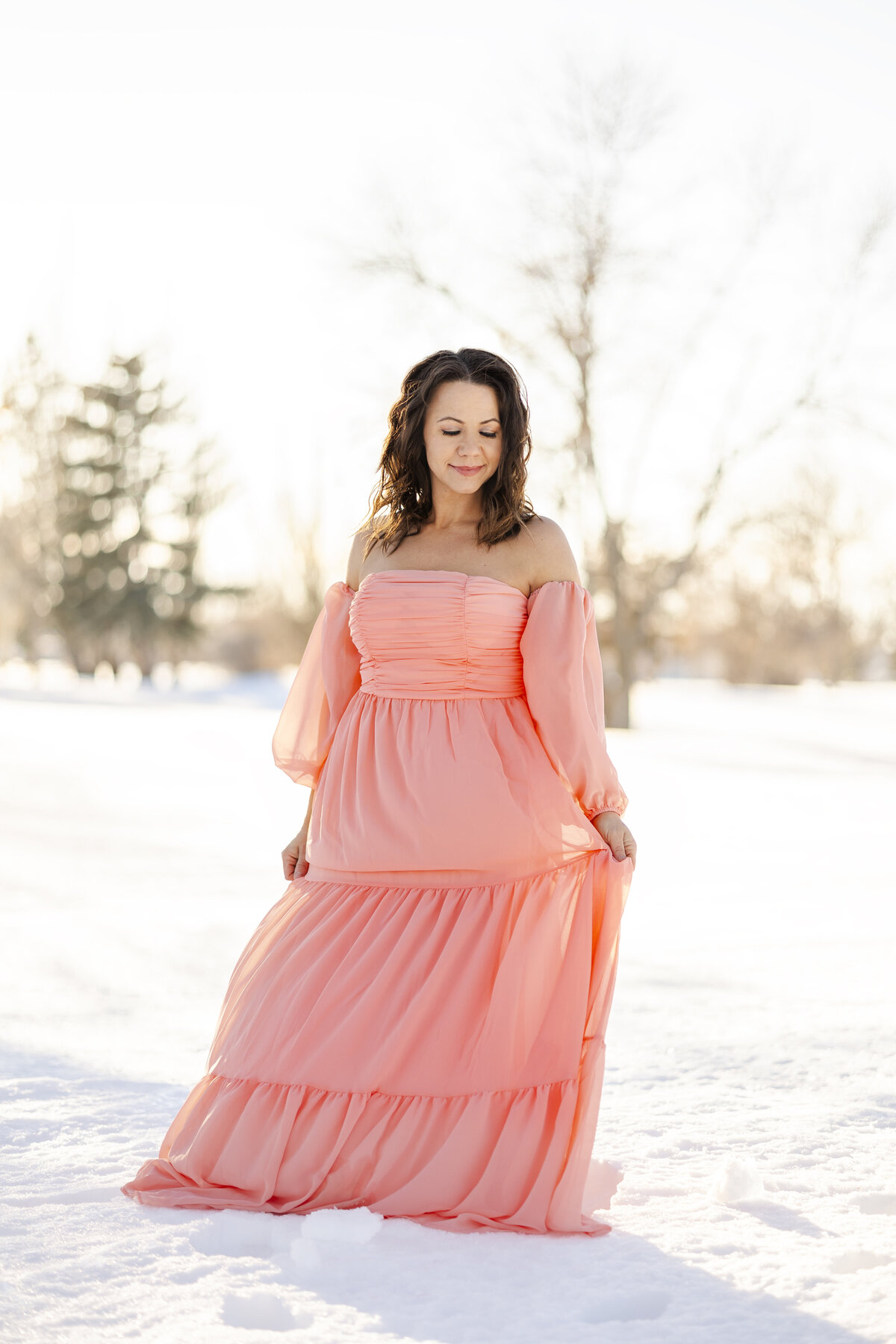 Colorado Springs Photographer- woman standing in pink dress in snow
